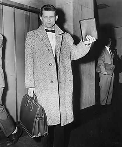 History - David Wilkerson holding a briefcase and book