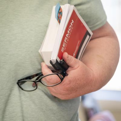 AHWC - Client carrying sermon book and notes