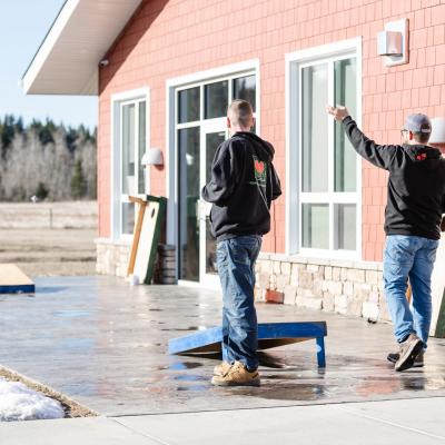 ABMC - clients playing bean bag toss outside