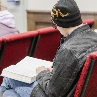 ABMC - client in chapel, reading Bible