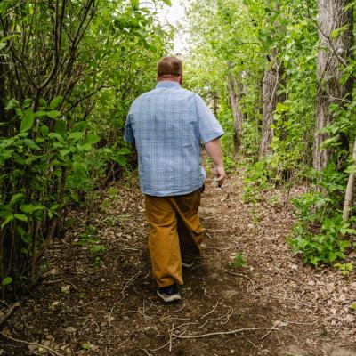 SKMC client walking along forested path