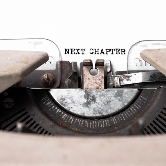 Typewriter with "Next Chapter" on paper