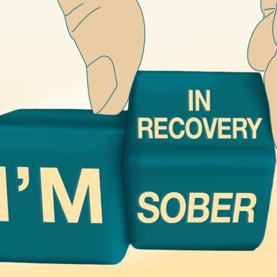 Hand rotating blocks that say I'm in recovery/sober